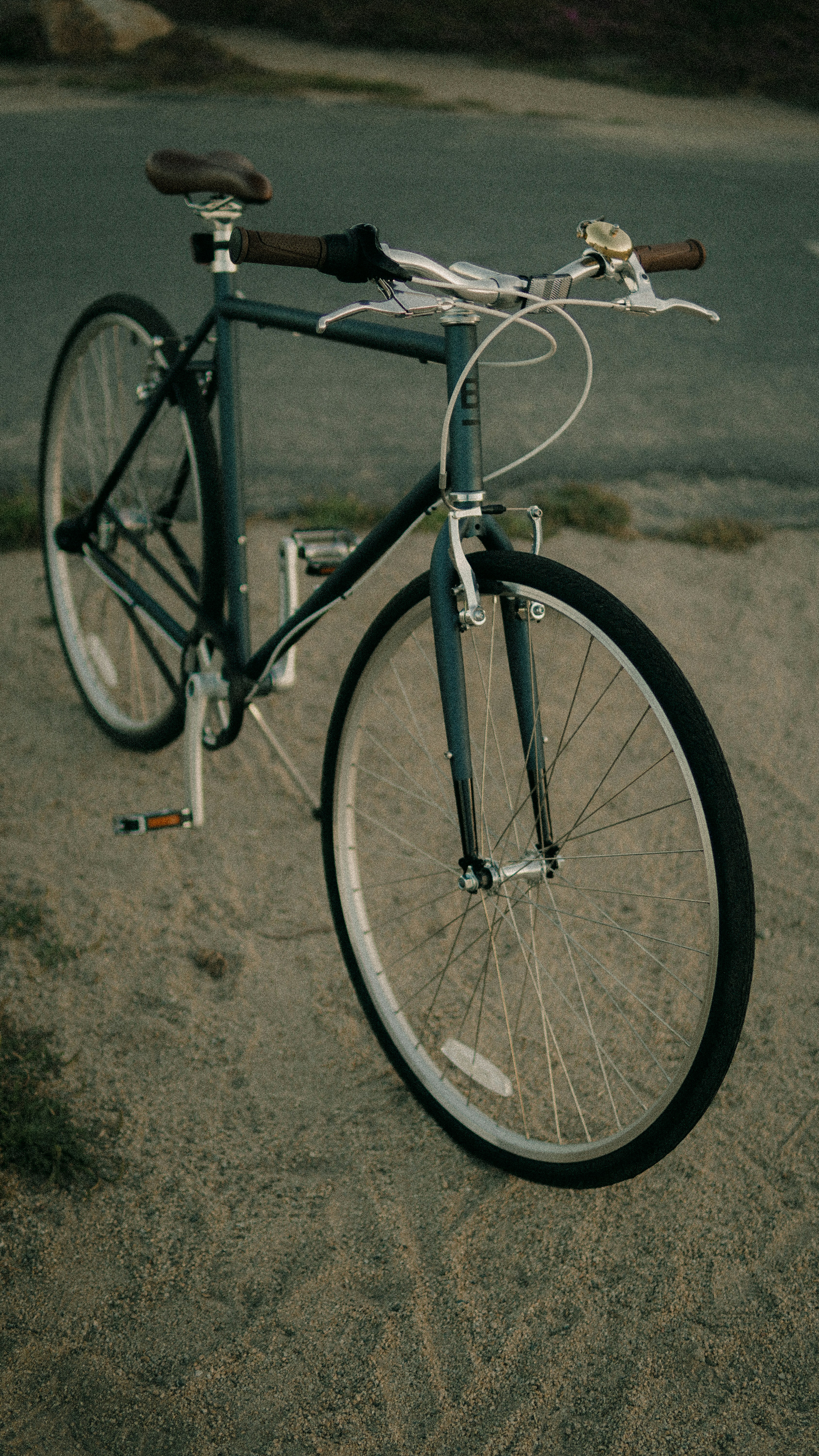 A dark green city bicycle — the kind you'll find at Cyclone Cycles